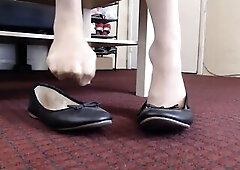 Whilst wearing naked hose dipping toe wiggling in ebony ballet flats.