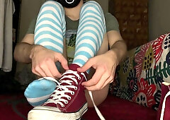 Femboy dressed in Chat, hip high socks and demonstrating nude soles