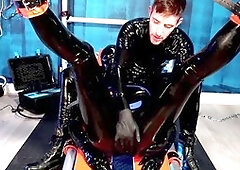 Alpha dom uses a fucking machine on his gay slave in a latex dungeon