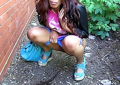 Black angel pissing in public