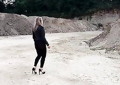Grandma is walking around a gravel pit in taut leggings and high heels!