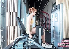 Redhead checking her taut gym outfit in the mirror for u