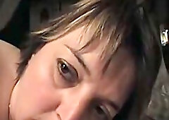 A granny is down on her knees and sucking on her husband's half limp dick