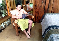Dark-haired woman tempts bearded man reading alone in rustic room