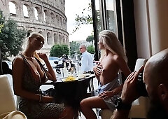Two beautiful busty blondes posing topless in public