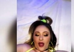 Aria Six shines dazzlingly in the dimly lit room with her bright smile and neon yellow bikini. Her nylons and fishnet arm sleeves complete her hot loo