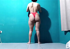 Curvy shemale in red panties enjoying a pink cigar