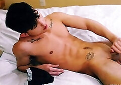 Tattooed gay jerking big dick in the bed