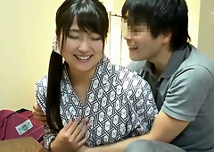 Asian woman in kimono kisses man in traditional Japanese room