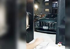 Sissy in chastity trying to gulp a full bottle of beer via anal in the open door