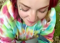 Slender redhead college student gives outdoor blowjob in forest