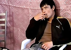Horny young man smoking before stripping and jerking off solo