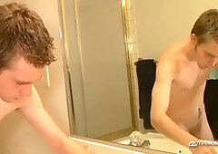 Young man drains hung cock while puffing a cigarette