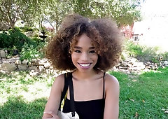 Curly haired teenie with beautiful smile sucks hard pecker outdoors