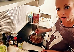 Great blonde chick in black boots is sitting on the chair and rubbing her juicy slit