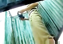 A angel dresses pants in the changing room at the beach.