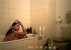 Brunette cutie enjoys a hot shower in the bathroom