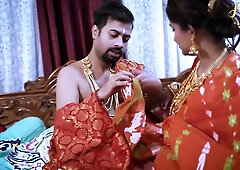 Passionate lovers entwined in a richly decorated bedroom adorned with gold and silk
