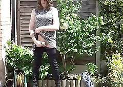 Sexy masturbating crossdresser in thigh boots outdoors