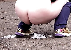 big beautiful woman with a old butt was walking along the road and wanted to urinate. This Babe takes off her jeans and pants and voids urine. A golde