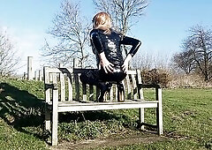 T-Girl CD bitch stripping, posing  and stroking on a park bench, wearing pvc