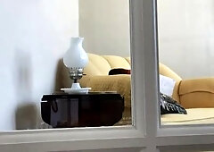 Exhibitionist performs for the spycam in you observing thru a glass door