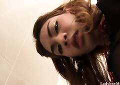 Teen Thai transsexual Kitty lifts short petticoat up. Kitty exposes her uncut wang and small booty. Kitty takes water enema and bangs herself with a b