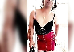 Wearing a vinyl mini red petticoat that squeaks like a siren underneath traffic lights, ebony lace barely caging the chest, laddered fishnets flashing