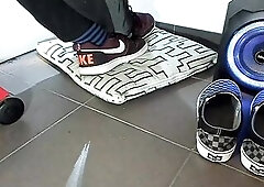 Boy shoeplay and stomping stuff at home in Nikes, Vans, blue stiped socks