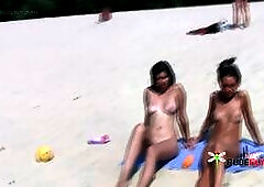 Ravishing young nudist babes secretly filmed by a voyeur relaxing at the beach
