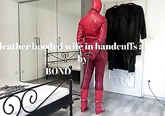 Red leather hooded wife in handcuffs and chains