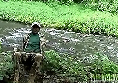 Brown soldier strips naked by the stream