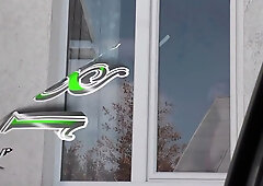 Blonde in black stockings cleans window then strips topless for exhibitionist show