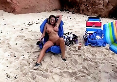 Big breasted MILF housewife posing naked on the beach