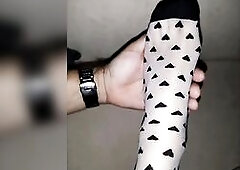 Relaxing foot massage - nude feet and nylon socks (close-up)