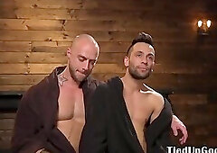 Suspended bdsm sub caged for cock tugging