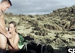 Cute golden-haired bangs fortunate boyfriend in wild volcanic landscape