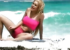 Showing off my round hot curves at the beach in a taut pink top that clings to my round titties and constricted pink short shorts that make my booty l