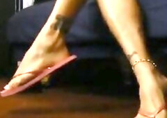 Leg view to pink flips flops, natural shoe play. toe pointing, great arched feet. Imagine being and getting a peek toe show an i don't even know 