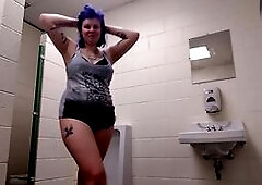Watch this naughty amateur with blue hair and tattoos shake her big ass and boobs in a public men's restroom at UW-Milwaukee. She's not afra