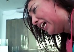 Two women use a strap on in the kinky scene on one another