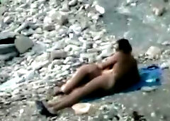Nudist fucked rough on rocky beach