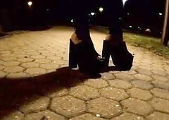 crossdresser in high heel mules walks on the street