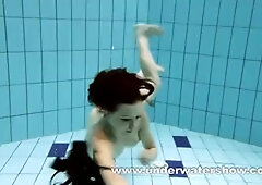 Brunette Kristy is stripping underwater
