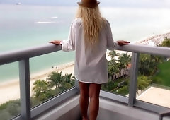 Sexy blonde MILF on vacation flashing her huge tits on the hotel balcony
