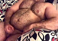 Hairy man lounging on the couch