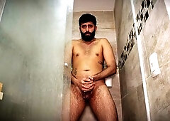 Daddy Camilo Brown plays with his huge uncut cock in the shower and releases his load