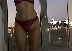 I dance and fondle myself near the window so passersby can watch my exposed body