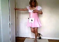 Pink maid's outfit with nude pantyhose and heels