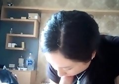 Striking Korean milf gives a nice massage and a hot blowjob
